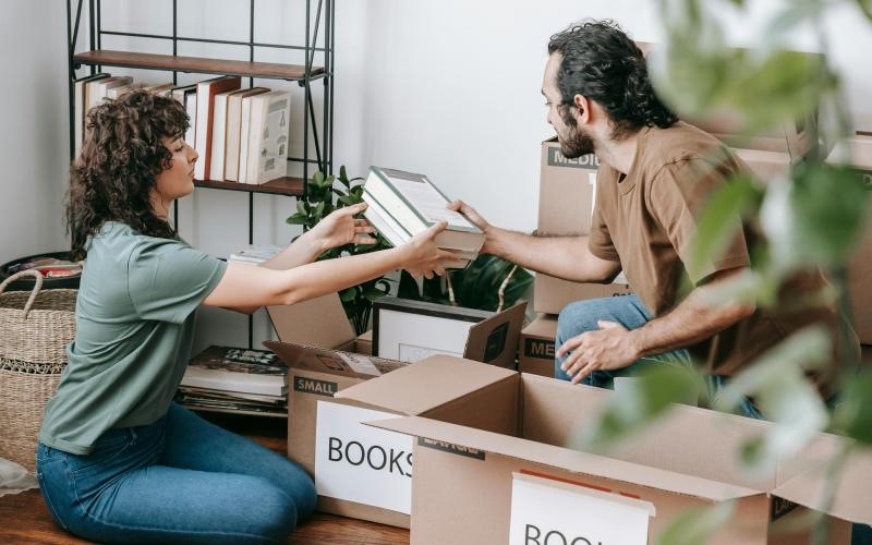 a man and a woman emptying boxes