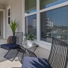 a patio with a table chairs and a window with blinds