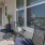 a patio with a table chairs and a window with blinds