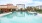 a swimming pool with a building in the background