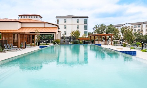 a swimming pool with a building in the background