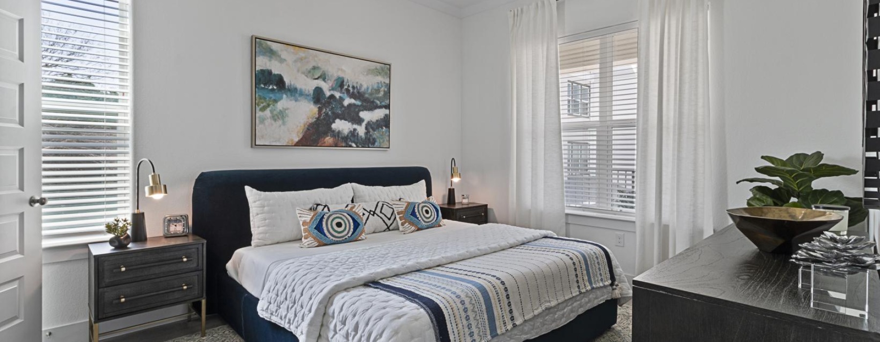 a bedroom with a bed and side tables