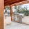 a covered patio with a grilling area
