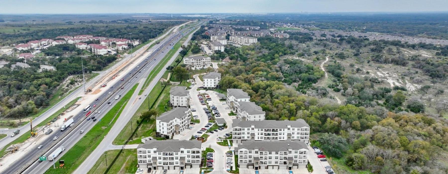 a highway with buildings and trees