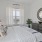 a bedroom with a large mirror