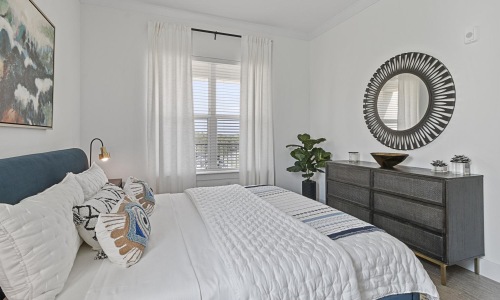 a bedroom with a large mirror