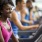 a person smiling standing on a treadmill