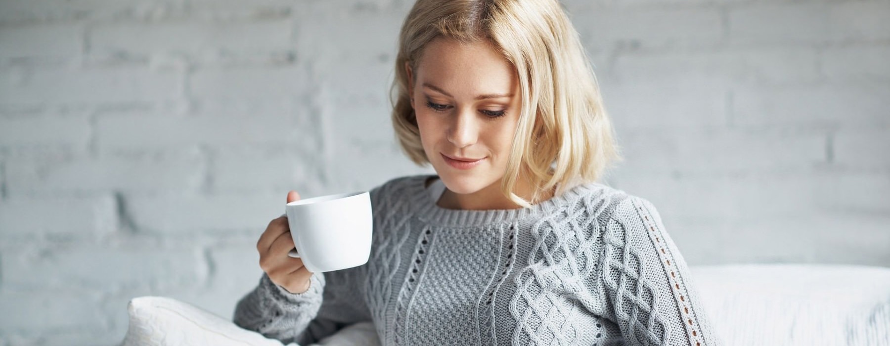 a woman holding a coffee cup