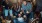 a group of people celebrating in a living room