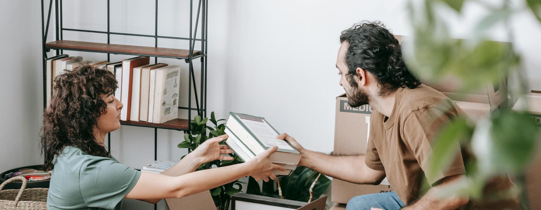 a man and a woman emptying boxes