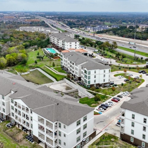 Settle into comfort at Reveal at Onion Creek aerial view of a multi-level building