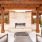 a patio with a fireplace and chairs